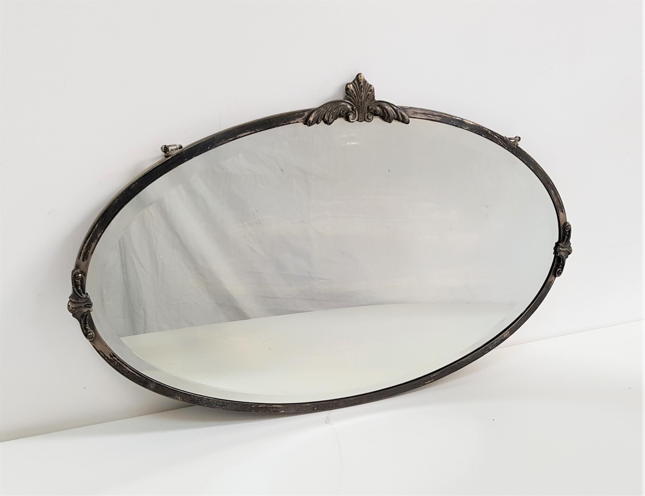 OVAL METAL FRAME WALL MIRROR with a bevelled plate, 69cm wide