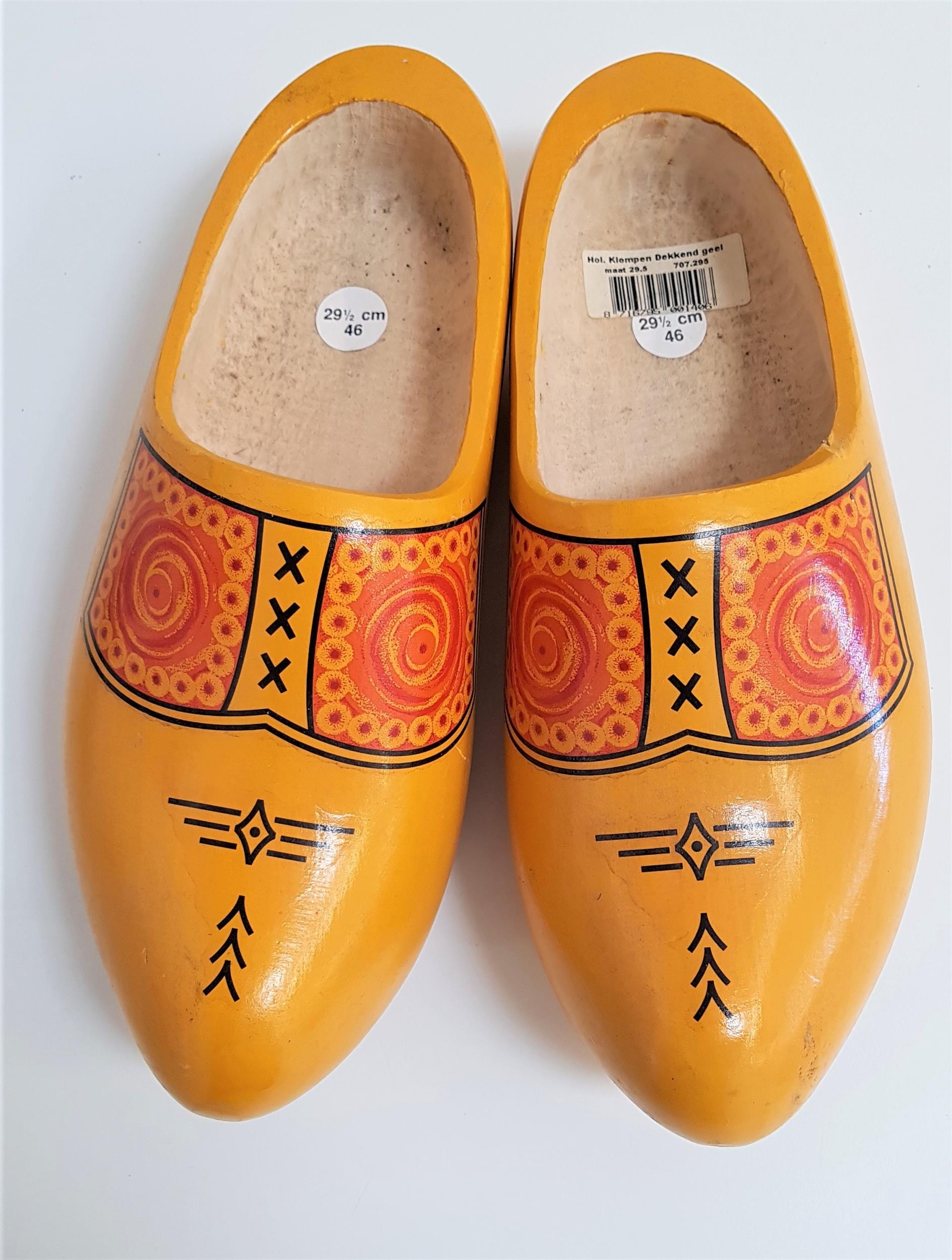 PAIR OF DUTCH CARVED CLOGS of one piece construction and painted yellow with a geometric design,