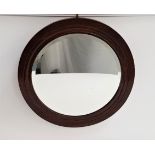 1930s CIRCULAR OAK FRAME WALL MIRROR with a bevelled plate, 54cm diameter