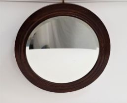 1930s CIRCULAR OAK FRAME WALL MIRROR with a bevelled plate, 54cm diameter