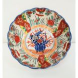 JAPANESE IMARI BOWL with a wavy rim and decorated with flowers, 18.5cm diameter