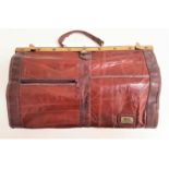 MARC CHANTAL LEATHER GLADSTONE TYPE BAG with a carry handle and brass fitting and locks, a leather
