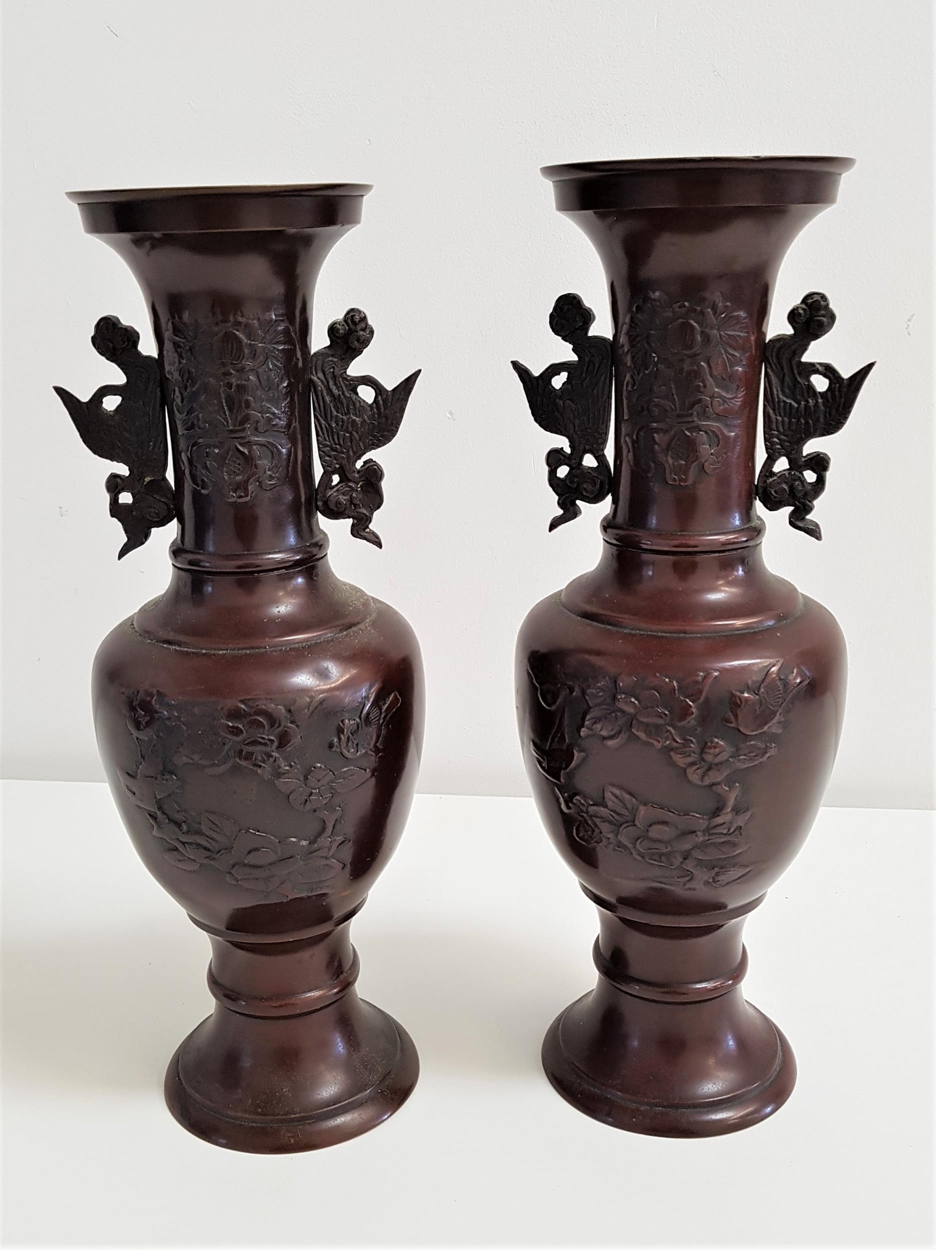 PAIR OF CHINESE HU SPELTER VASES with Archaic bird decoration, raised on a circular base, 32cm