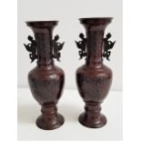 PAIR OF CHINESE HU SPELTER VASES with Archaic bird decoration, raised on a circular base, 32cm