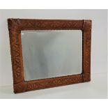 RECTANGULAR WALL MIRROR with a leather covered embossed frame with decorative stud detail and a