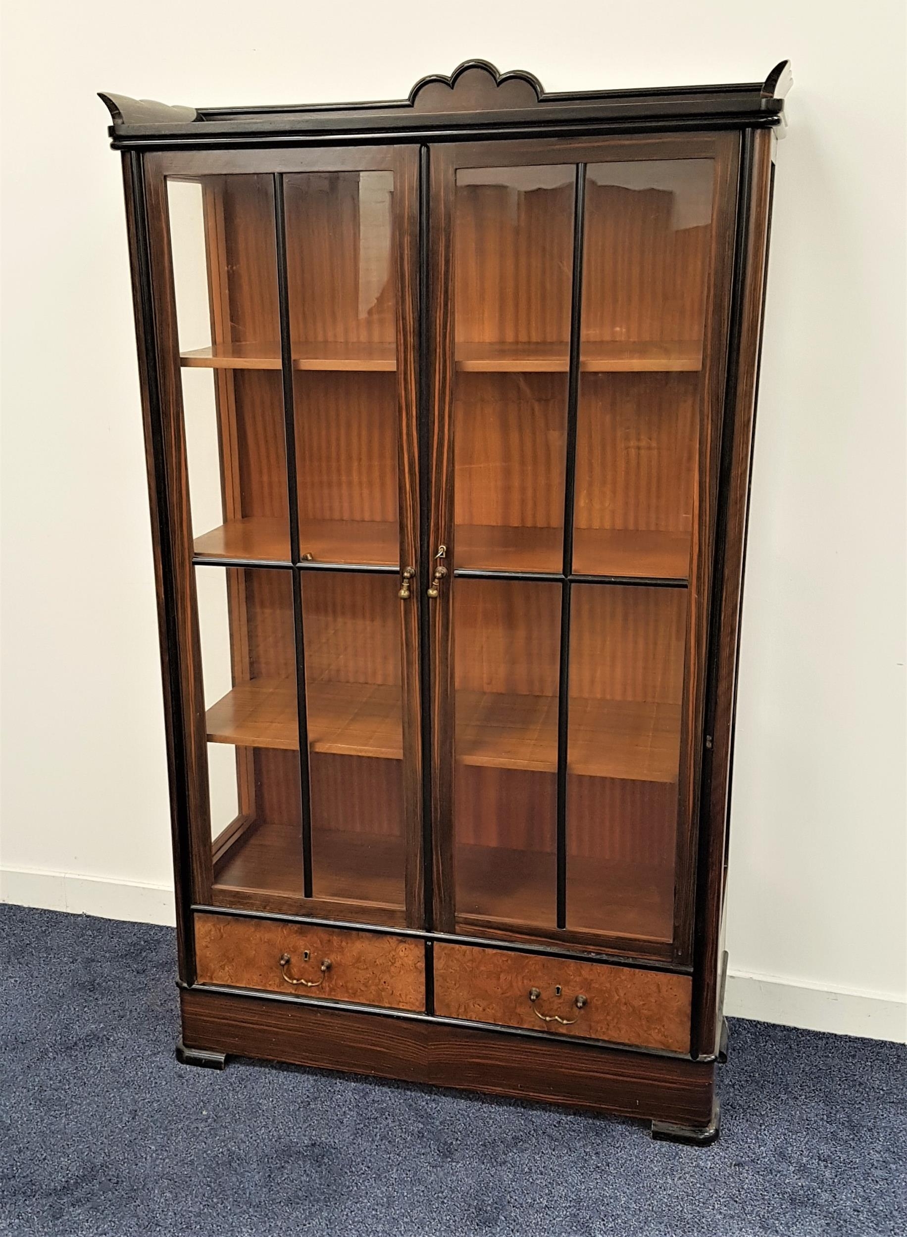 1930s COROMANDEL DISPLAY CABINET with a three quarter gallery top with a carved fan detail above two