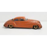 VENTURA TIN PLATE MUSICAL CAR with a caramel body and white wall tyres, with a wind up key to the