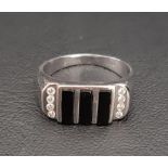 FOURTEEN CARAT WHITE GOLD DRESS RING with vertical black agate bars and diamond shoulders, ring size