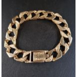 HEAVY NINE CARAT GOLD CURB LINK BRACELET with alternating links of engraved design, approximately