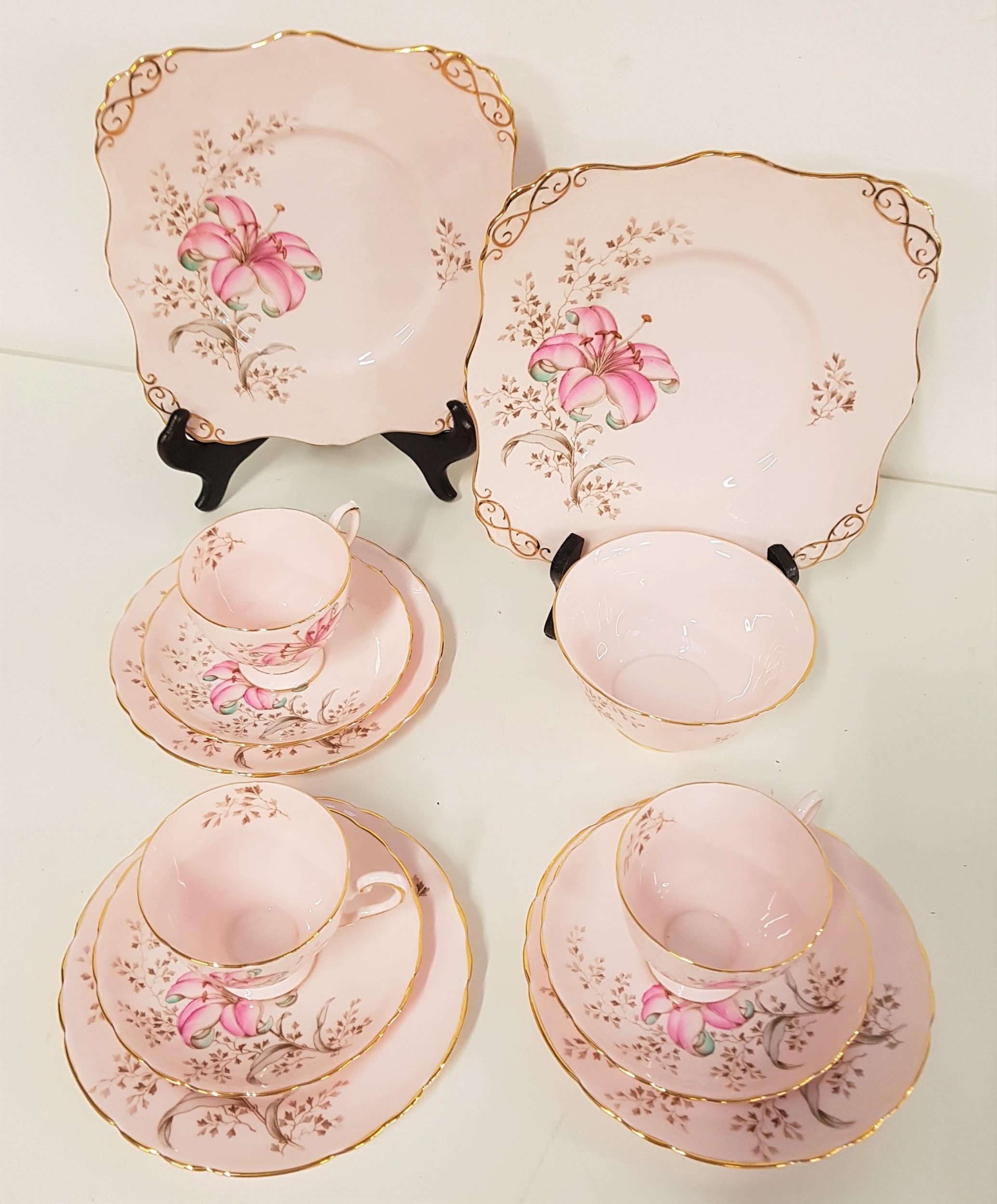 TEN PIECE TUSCAN BONE CHINA TEA SET with a lily design on a pink ground with gilt highlights,