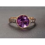 AMETHYST AND DIAMOND RING the bezel set round cut amethyst approximately 1.5cts flanked by three