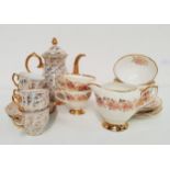 CLARE CHINA PART TEA SERVICE decorated with a cream ground with a floral border with gilt