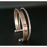 FOURTEEN CARAT GOLD AND STERLING SILVER STACKED CUFF BRACELET comprising two sterling silver