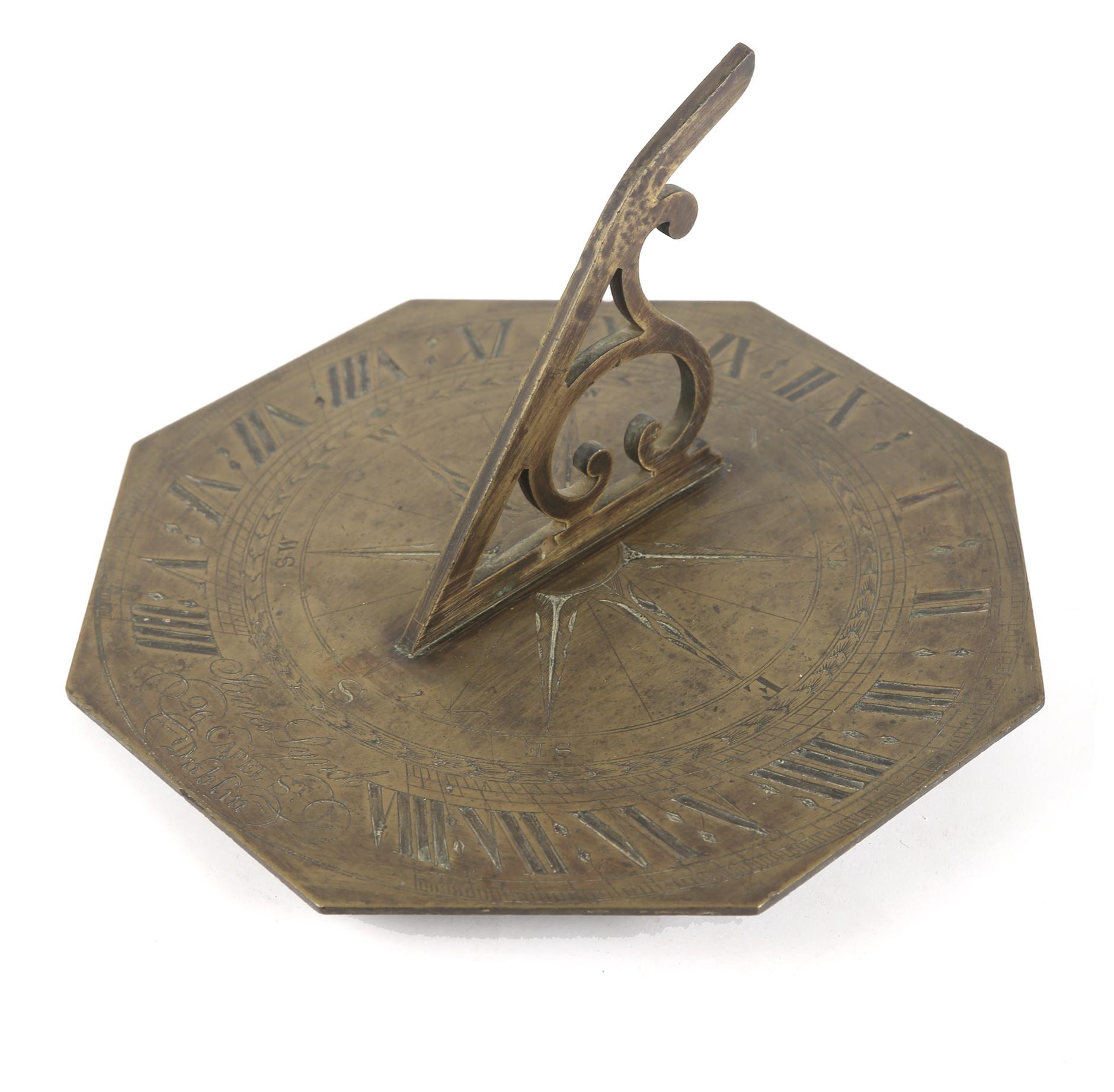 An early 19th century brass octagonal sundial, the scrolled gnomon centred on a finely engraved