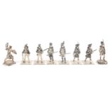 A collection of eight silver military figures. French Grenadier 1815 'Parade Dress' and 'Active