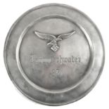 A pewter circular plate high-relief decorated with a Luftwaffe eagle and swastika above "