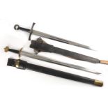 Two medieval-style swords. A modern replica of a greatsword, the long, tapered, broadly fullered