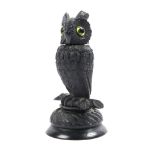 a Victorian bog oak vesta in the form of a long-eared owl, the head with green glass eyes, lifting