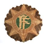 Oglaigh na hEireann, a hand knotted circular rug in the form of the badge of the Defence Forces, the