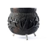A carved bog oak cauldron, the body relief-carved with trailing shamrock, wolfhound and harp, on
