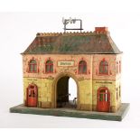 Marklin Gauge 1 tinplate station building, for the English market, c1905, mounted on a green base,