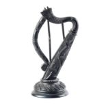 A Victorian carved bog oak harp, the body relief carved with shamrock, on carved, domed base, 5½" (