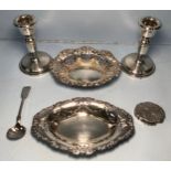 A small collection of assorted silver items comprising a pair of weighted candlesticks by W I