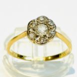 An 18ct yellow gold daisy cluster ring, set to the centre with a Victorian cut diamond, surrounded