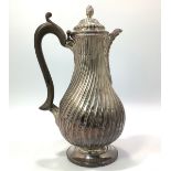 A Victorian silver hot-water jug, of baluster form, London, 1880, with finial on hinged dome