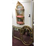 A heavy oval gilt framed mirror with compartmented borders, 100 x 71cm, together with a pier