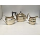A three-piece silver tea service by George Nathan & Ridley Hayes, comprising teapot, milk jug and