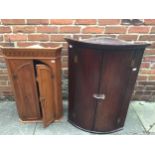 A George III mahogany bow-fronted hanging corner cupboard, with moulded cornice, above two