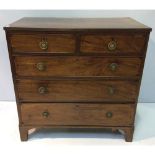 A George III mahogany chest of two short, over three long, graduated drawers with brass pulls and