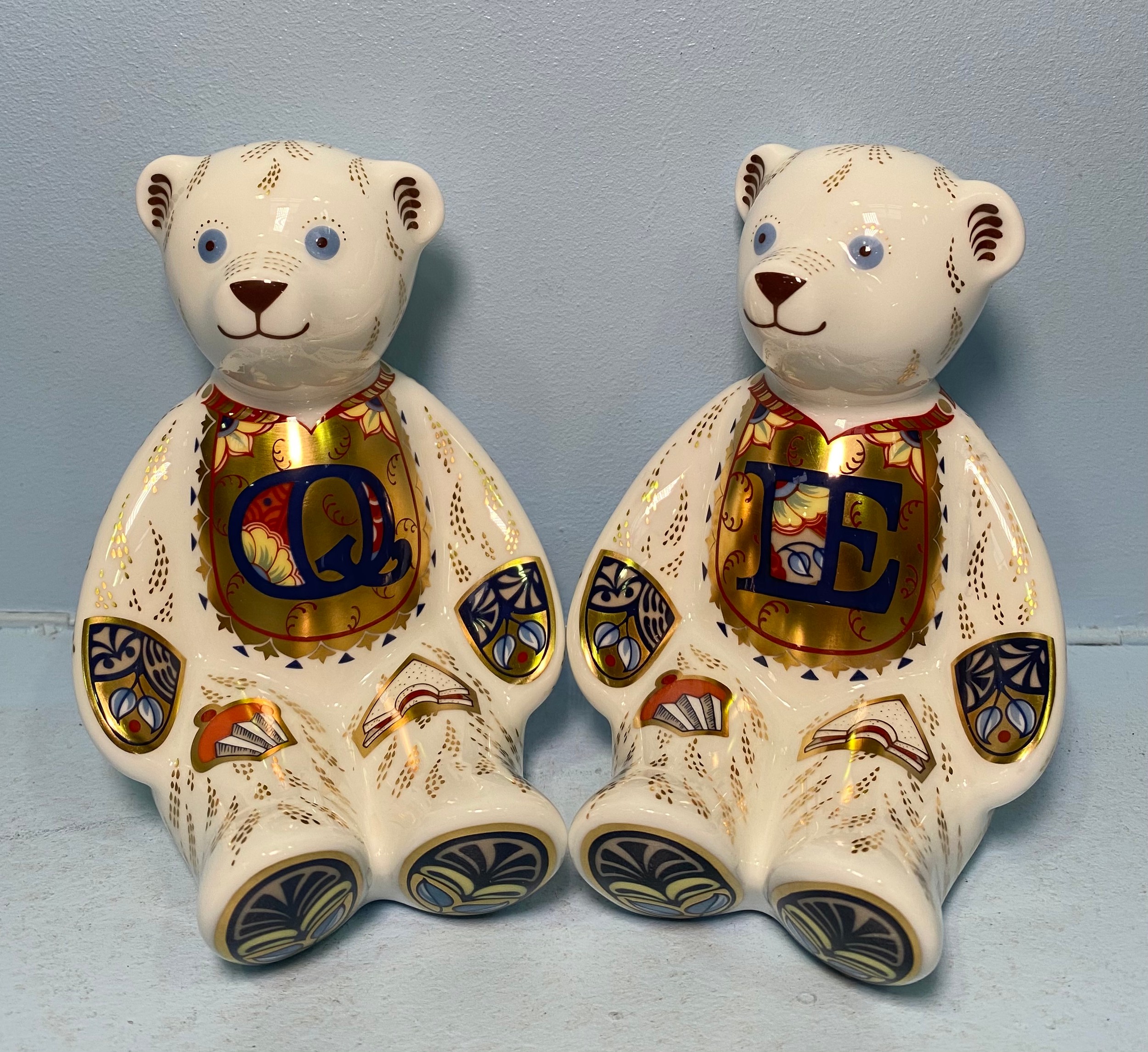 A pair of Royal Crown Derby Alphabet Bears, 'E' and 'Q', with printed marks to base, gold stoppers