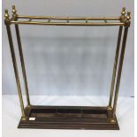 A brass six-division umbrella/stick stand, with four columns, raised on stepped and splayed