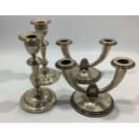 A pair of loaded silver candlesticks by Ellis & Co (Ellis Jacob Greenberg) with horizontal, reeded