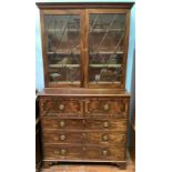 A large Georgian mahogany secretaire bookcase with astragal glazed doors above chest with fall front