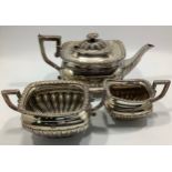 An Edwardian three-piece silver tea service by Robert Pringle & Sons, with leaf moulded decoration