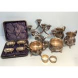 A cased set of Edwardian silver open salts, with shaped bodies and raised on four pad feet,
