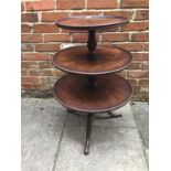 A late 19th century mahogany three-tier dumb waiter, each tier of graduated size and moulded rim,