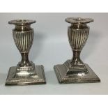 A pair of Edwardian squat silver candlesticks by Fordham & Faulkner (William Charles Fordham &