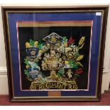 A framed montage of Rogers's Company Royal Artillery badges and crests with a plaque 'Presented to