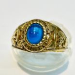 A 9ct yellow gold Cambridge university graduation ring, set with a blue cabochon stone to the
