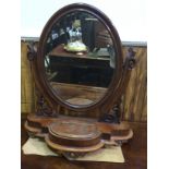 A 19th century walnut oval platform mirror, raised on shaped base with hinged lidded compartment and