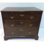 A George III mahogany bachelors chest of drawers, with brushing slide, above three long, graduated