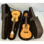 Two similar Hudson ukuleles, model HUK-SMCE, with internal electrical pickup, pine top and burr-wood