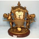 A mantel clock modelled as a litter being carried by two cherubs, the litter enclosing movement,