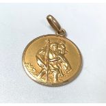 An 18ct St Christopher pendant, the reverse with 1950s car driving in an Alpine landscape, 4.47g,