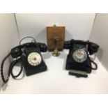 A French black bakelite telephone together with another black bakelite telephone and a battery