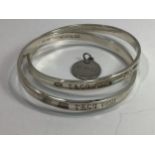 A Tiffany & Co silver stiff bangle formed as two interlocking bangles, each marked '925 T & Co